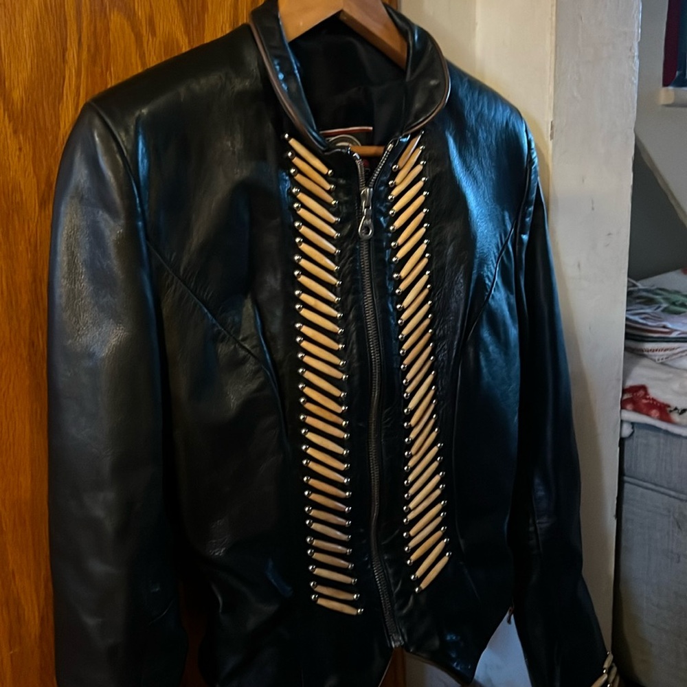 Leather motorcycle jacket with bone detail. Super warm. Perfect condition.